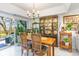 Elegant dining room features beautiful chandelier, wooden table, and decorative cabinet at 276 Salt Marsh Circle # 4D, Pawleys Island, SC 29585
