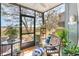 Relaxing screened porch with comfortable seating and views of the surrounding trees at 276 Salt Marsh Circle # 4D, Pawleys Island, SC 29585