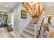 Carpeted staircase featuring white wood trim and a stylish painting on the wall at 276 Salt Marsh Circle # 4D, Pawleys Island, SC 29585