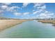 Expansive waterfront view of a tranquil river bordered by native marsh grasses and homes at 276 Salt Marsh Circle # 4D, Pawleys Island, SC 29585