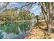 Scenic water view with fountain, palm trees and mature trees lining the banks at 276 Salt Marsh Circle # 4D, Pawleys Island, SC 29585