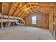 Unfinished attic space with exposed rafters, ductwork, and a window providing natural light at 2825 Stellar Loop, Myrtle Beach, SC 29577