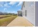 Home's backyard showcasing patio, manicured lawn, and serene pond views, offering outdoor enjoyment at 2825 Stellar Loop, Myrtle Beach, SC 29577