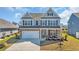 Charming two-story home featuring a brick-accented facade, two-car garage, and a beautifully landscaped front yard at 2825 Stellar Loop, Myrtle Beach, SC 29577