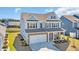 Aerial view of a blue two-story home with a two car garage, beautiful front porch, and a well-manicured front lawn at 2825 Stellar Loop, Myrtle Beach, SC 29577