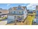 Aerial view of a blue two-story home with a two car garage, beautiful front porch, and a well-manicured front lawn at 2825 Stellar Loop, Myrtle Beach, SC 29577