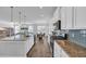 Spacious kitchen featuring white cabinets, stainless steel appliances, granite counters, and open to dining area at 2825 Stellar Loop, Myrtle Beach, SC 29577