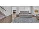Relaxing living room with reclining sofa, wood floors, and stairway to upper level at 2825 Stellar Loop, Myrtle Beach, SC 29577