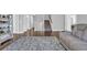 Open-concept living area with hardwood floors, leather recliner, and view of the stairway at 2825 Stellar Loop, Myrtle Beach, SC 29577