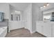 Main bathroom boasts double sinks, a large mirror, and separate vanities with white cabinets at 2825 Stellar Loop, Myrtle Beach, SC 29577