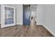 Versatile room with neutral walls, wood-look tile flooring, double french doors, bright window, and a sliding barn door at 2825 Stellar Loop, Myrtle Beach, SC 29577