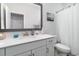 Clean bathroom featuring a vanity with white countertop, framed mirror, and a shower with curtain at 294 Portofino Dr., Myrtle Beach, SC 29579
