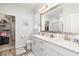 Bright bathroom featuring a double sink vanity, large mirror, and a separate closet for optimized storage at 294 Portofino Dr., Myrtle Beach, SC 29579