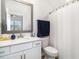 Bright bathroom featuring a vanity with a sink and modern fixtures, complemented by a shower with a curtain at 294 Portofino Dr., Myrtle Beach, SC 29579