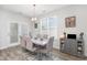 Elegant dining room with a modern table, stylish chairs, and natural light from a large window at 294 Portofino Dr., Myrtle Beach, SC 29579