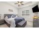 Spacious main bedroom featuring a ceiling fan, window with blinds, and stylish furnishings at 294 Portofino Dr., Myrtle Beach, SC 29579