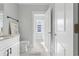 Bathroom featuring marble floors, a toilet, modern vanity and a window with natural light at 305 Lineback Pl. # 33, Longs, SC 29568