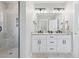 Bathroom featuring double vanity, marble countertops, sleek fixtures, and a walk-in shower at 305 Lineback Pl. # 33, Longs, SC 29568