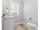Well-lit half bathroom with modern fixtures and granite countertop sink at 305 Lineback Pl. # 33, Longs, SC 29568