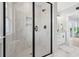 Bathroom with walk-in shower, marble tile, black framed glass door, and modern vanity at 305 Lineback Pl. # 33, Longs, SC 29568