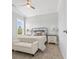Cozy bedroom features a ceiling fan, a bed with decorative pillows, and matching bedside tables at 305 Lineback Pl. # 33, Longs, SC 29568