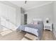 Bedroom featuring striped bedspread, light colored walls, and wood look floors at 305 Lineback Pl. # 33, Longs, SC 29568