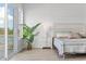 Bright bedroom with a large window, patterned quilt, white shiplap walls, and wood-look flooring at 305 Lineback Pl. # 33, Longs, SC 29568