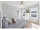 Bedroom featuring a striped bedspread, bright windows, and light gray walls at 305 Lineback Pl. # 33, Longs, SC 29568