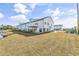 A multi-story white townhouse with a deck, surrounded by a well-maintained green lawn at 305 Lineback Pl. # 33, Longs, SC 29568