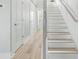 Bright hallway with wood-look floors and a staircase with white risers at 305 Lineback Pl. # 33, Longs, SC 29568