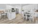 Bright kitchen features white cabinets, stainless steel appliances, granite counters, and an adjacent dining area at 305 Lineback Pl. # 33, Longs, SC 29568