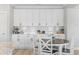 Bright kitchen features white cabinets, subway tile backsplash, granite counters, and an adjacent dining area at 305 Lineback Pl. # 33, Longs, SC 29568