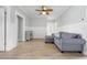 Comfortable living room with a modern couch, ceiling fan, and stylish decor at 305 Lineback Pl. # 33, Longs, SC 29568