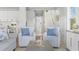 Inviting seating area features decorative chairs with an open concept view of the white staircase and kitchen at 305 Lineback Pl. # 33, Longs, SC 29568