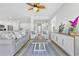 Open-concept living room with stylish furniture, wood-look floors, and seamless connection to the kitchen at 305 Lineback Pl. # 33, Longs, SC 29568
