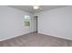 Bedroom with carpet flooring, ceiling fan, window, and a door that leads to another room at 324 Mayflower Dr., Calabash, NC 28467