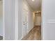 Hallway featuring wood flooring, white doors and trim, and neutral-colored walls at 324 Mayflower Dr., Calabash, NC 28467