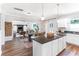 Kitchen island with bar seating overlooking dining and living spaces with an open floor plan at 324 Mayflower Dr., Calabash, NC 28467
