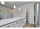 Kitchen island with white countertop, view to pantry and stainless steel refrigerator at 324 Mayflower Dr., Calabash, NC 28467
