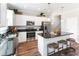 Well-equipped kitchen with an island and breakfast bar, featuring stainless steel appliances at 324 Mayflower Dr., Calabash, NC 28467