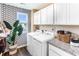 Well-equipped laundry room with modern appliances, stylish wallpaper, and ample storage at 324 Mayflower Dr., Calabash, NC 28467