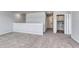 Open living area with neutral carpet, white trim, and doorway to a laundry room at 324 Mayflower Dr., Calabash, NC 28467