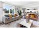 Bright living room with hardwood floors and an open concept, seamlessly flowing into the kitchen and dining area at 324 Mayflower Dr., Calabash, NC 28467