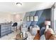 Cozy living room with a brown leather sofa, two armchairs, accent wall and a stylish bar at 324 Mayflower Dr., Calabash, NC 28467