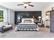 Comfortable main bedroom featuring a dark wood accent wall, neutral furnishings, and natural light at 324 Mayflower Dr., Calabash, NC 28467