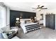 Comfortable main bedroom featuring a dark wood accent wall, neutral furnishings, and natural light at 324 Mayflower Dr., Calabash, NC 28467