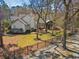 Spacious backyard with patio, garden, and mature trees, enclosed by a fence at 356 Savannah Dr., Pawleys Island, SC 29585