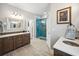 Modern bathroom with double vanity, tiled floors, and a glass-enclosed shower at 356 Savannah Dr., Pawleys Island, SC 29585