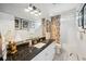 Bright bathroom with black granite countertop, white cabinets, and marble floors at 356 Savannah Dr., Pawleys Island, SC 29585