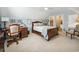 Bright bedroom with a wooden bed frame, a desk with shelving, and a comfortable chair at 356 Savannah Dr., Pawleys Island, SC 29585